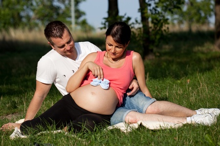 pregnant woman and man - parkの写真素材