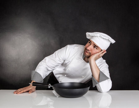 Thinking chef on black background  No ideaの写真素材