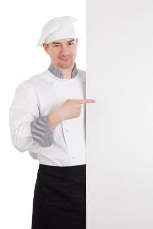 Chef pointing finger to white blank boardの写真素材