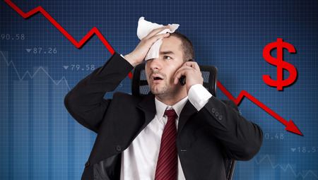 Dollar crisis, currency collapse. Broker holding foreheadの写真素材