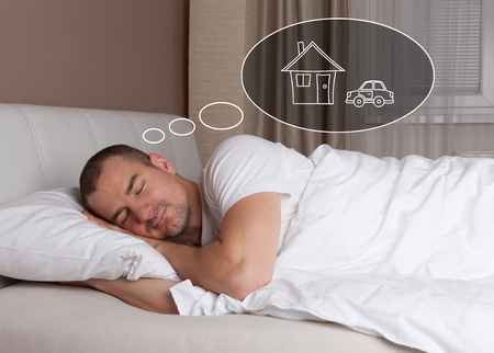Sleeping young man and dreaming  about new house and carの写真素材