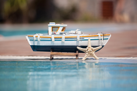 Close up of model ship next to the swimming pool. Blur Backgroundの写真素材