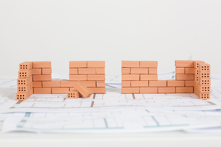 Model house construction with brick on blueprintの写真素材