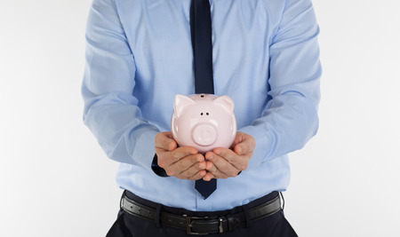 Close up of  businessman holding pig money box in hands.の写真素材
