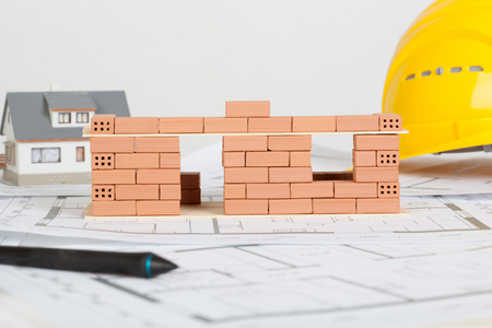 Model house construction with brick on blueprintの写真素材