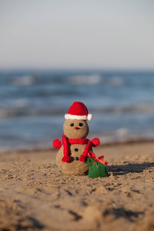 Sandy snowman at tropical beach. Holiday concept - New Year's and Christmas Cardsの写真素材