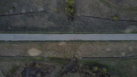 Road on the Faroe Islands countryside, surrounded by grass and sheep. Aerial view.の写真素材