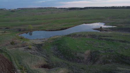 Top view on the lake between hills in the evening light.の写真素材