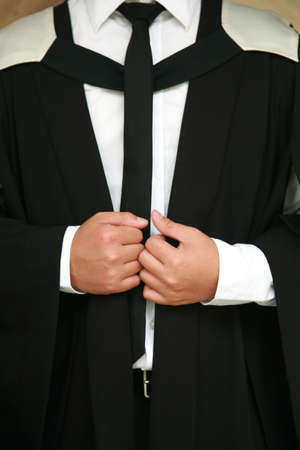 Asian male wearing a university graduation gownの写真素材