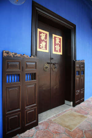Chinese style door in a blue mansion of Penang, Malaysia.の写真素材