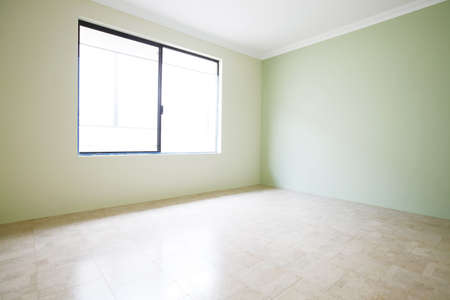 Empty room with cork flooring with green wallsの写真素材