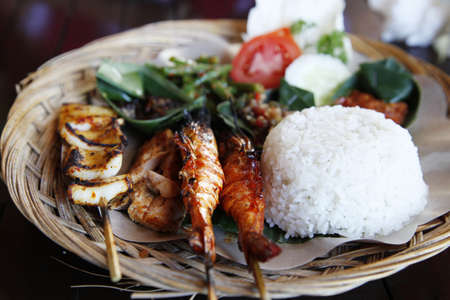 Traditional seafood satay and rice in Bali, Indonesia.の写真素材