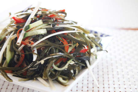 Seaweed salad, a fusion Chinese/Japanese delicacy mixed into a plate.の写真素材