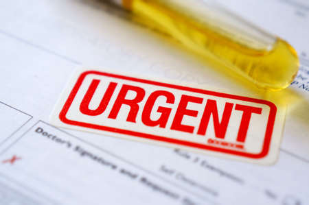 Urgent label with pathology test tube on order form  の写真素材