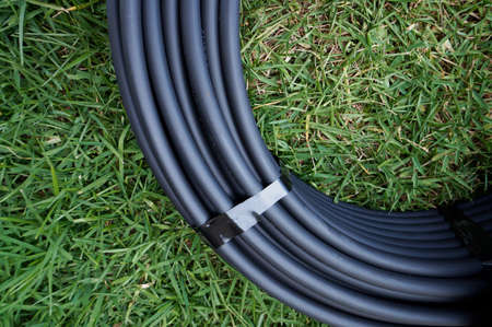 Irrigation and reticulation polypipe on green buffalo grassの写真素材