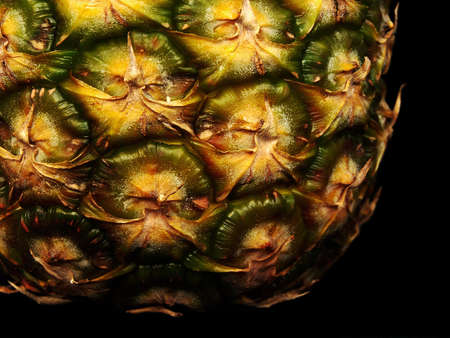 Slice of pineapple on a black background の写真素材