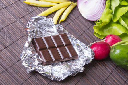 vegetables and chocolate on woodの写真素材