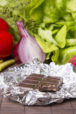 vegetables and chocolate on woodの写真素材