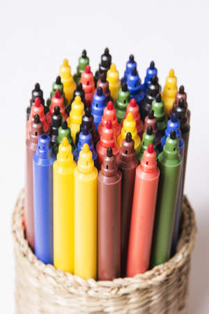 colored pens in a box on a light backgroundの写真素材