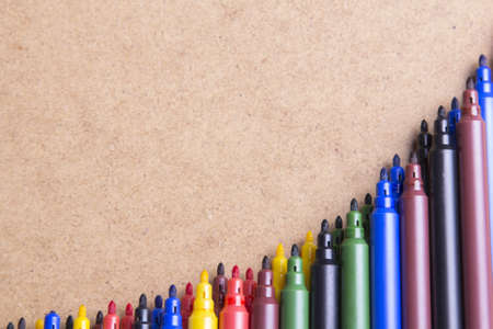 colored pens on a brown backgroundの写真素材