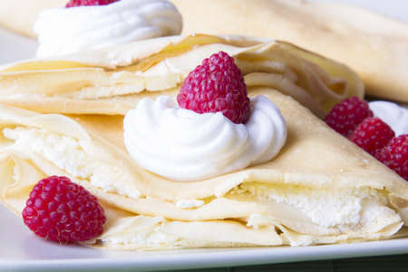 pancakes with whipped cream and raspberriesの写真素材