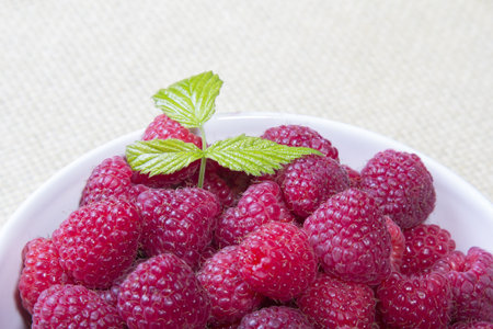 raspberries in a white bowl
