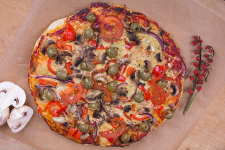 homemade pizza with olives, mushrooms and paprikaの写真素材