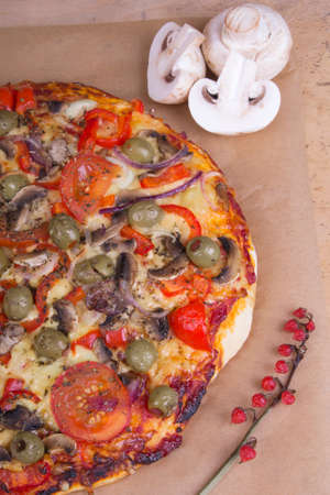 homemade pizza with olives, mushrooms and paprikaの写真素材