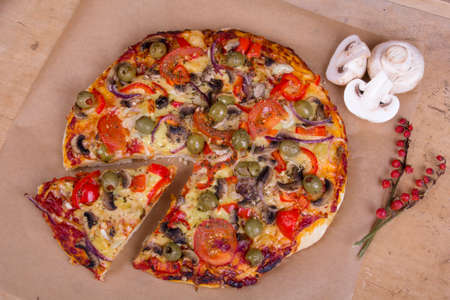 homemade pizza with olives, mushrooms and paprikaの写真素材