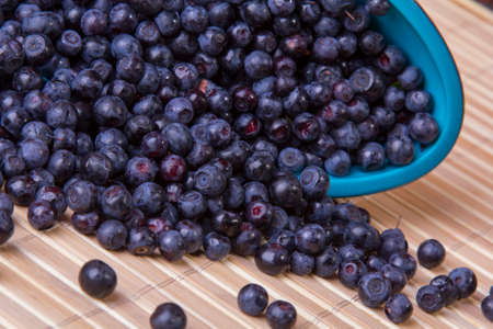 scattered blueberries on a woodenの写真素材