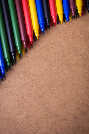colored pens on a brown の写真素材