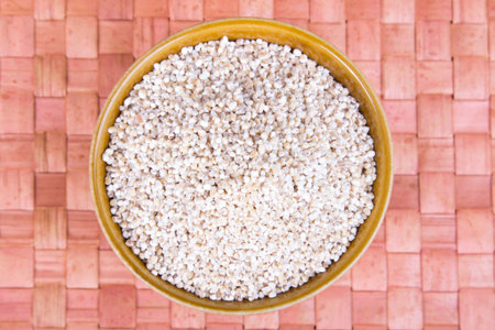 barley groats in a brown bowl