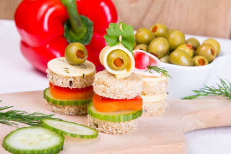 finger foods  bread, peppers, cucumber, cheese and olivesの写真素材