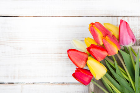 tulip bouquet on white wooden background