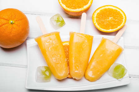 Homemade orange ice cream on a stickの写真素材