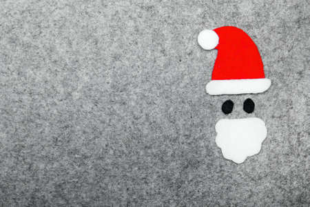 Santa Claus shapeon grey background. Felt Christmas ornaments with copy spaceの写真素材