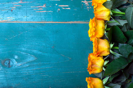 bouquet of orange roses on a wooden backgroundの写真素材