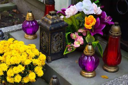 Graves decorations: flowers and votive candles. All Saints Day celebration in Polandの写真素材