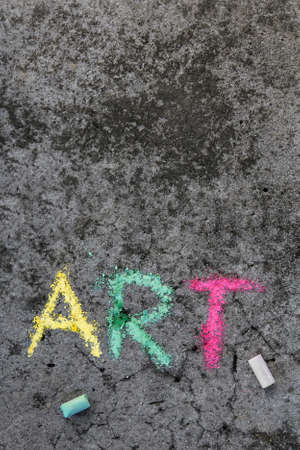 Colorful chalk drawing on sidewalk: Word ART and pieces of chalkの写真素材