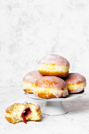 Traditional Polish donuts with frosting on lightの写真素材