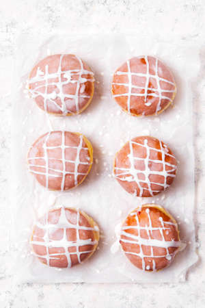 Traditional Polish donuts with frosting on lightの写真素材