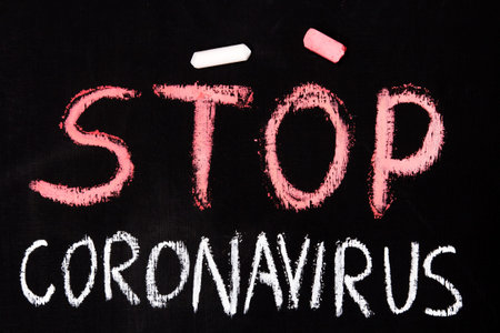Chalk writing with Stop Coronavirus
