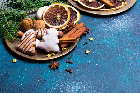 Beautiful Christmas background with decorations. Christmas cookies witch chocolate, gingerbread cookies, nuts and fir twigs on dark background. Copy space for your textの写真素材