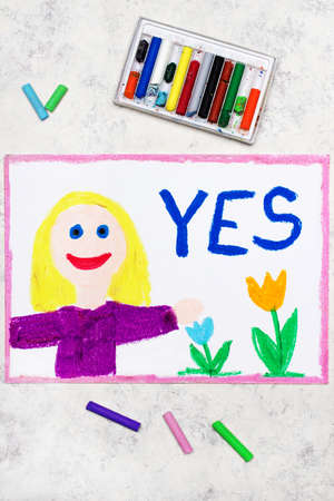 Colorful drawing: smiling blond girl and word YESの写真素材