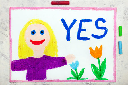 Colorful drawing: smiling blond girl and word YESの写真素材