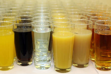 Lots of glasses filled up with different drinks の写真素材
