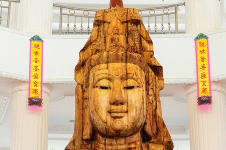 A beautiful wood statue of The Goddess of compassion and mercy in Chonburi, Thailand のeditorial素材