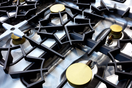 Close up of professional modern shining metal gas cooker in restaurant