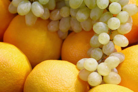 Oranges and grapes fruit backgroundの写真素材