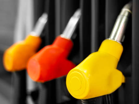 Yellow red fuel pistols on fuel station.の写真素材